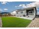 Backyard features artificial turf, concrete patio, gravel landscaping, and a wooden fence for privacy at 2159 Indian Balsam Dr, Monument, CO 80132