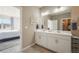 Well-lit bathroom featuring a double vanity and a view into the bedroom at 2159 Indian Balsam Dr, Monument, CO 80132