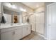 Bright bathroom featuring double sinks, a glass shower and a large mirror at 2159 Indian Balsam Dr, Monument, CO 80132
