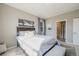 Inviting bedroom with a bed, neutral carpet and a view of a bathroom at 2159 Indian Balsam Dr, Monument, CO 80132