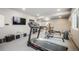 Well-equipped home gym featuring a treadmill and television at 2159 Indian Balsam Dr, Monument, CO 80132