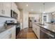 Kitchen with white cabinets, stainless steel appliances, and hard wood floors at 2159 Indian Balsam Dr, Monument, CO 80132