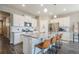 Kitchen with white cabinets, stainless steel appliances, and a large island with bar stool seating at 2159 Indian Balsam Dr, Monument, CO 80132