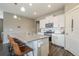 Kitchen with white cabinets, stainless steel appliances, and a large island with bar stool seating at 2159 Indian Balsam Dr, Monument, CO 80132