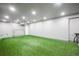 Spacious recreation room with green turf, ideal for indoor games and activities at 2159 Indian Balsam Dr, Monument, CO 80132