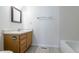 Bathroom features a sink, mirror, tile flooring, and a bathtub at 8463 Everett Way # B, Arvada, CO 80005