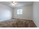 Bright bedroom features a ceiling fan and a window overlooking the property at 8463 Everett Way # B, Arvada, CO 80005