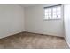 Neutral bedroom features a sunny window and comfortable carpeting at 8463 Everett Way # B, Arvada, CO 80005