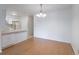 Open dining area with hardwood floors and a view of the kitchen, perfect for entertaining and Gathering meals at 8463 Everett Way # B, Arvada, CO 80005
