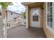 Inviting front porch featuring a white picket fence and a stylish exterior door with glass, enhancing curb appeal at 8463 Everett Way # B, Arvada, CO 80005