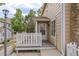 Cozy front porch with white picket fence and neutral siding offers a welcoming entrance to this charming home at 8463 Everett Way # B, Arvada, CO 80005