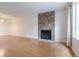 Spacious living room featuring a stone fireplace and large windows, offering a cozy and naturally lit space at 8463 Everett Way # B, Arvada, CO 80005