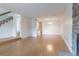 Open-concept living room with hardwood floors, staircase, and a glimpse of the kitchen, perfect for modern living at 8463 Everett Way # B, Arvada, CO 80005