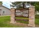 Timber Cove neighborhood entrance sign with stone pillars and well-maintained landscaping at 8463 Everett Way # B, Arvada, CO 80005