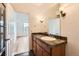 Bathroom boasts a tiled vanity, a large mirror and access to the bedroom at 3872 S Dallas St # 7-304, Aurora, CO 80014