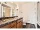 Bathroom with a tiled vanity, a large mirror and neutral walls at 3872 S Dallas St # 7-304, Aurora, CO 80014