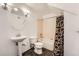 Bathroom featuring pedestal sink, toilet, tub, and dark tile flooring at 3872 S Dallas St # 7-304, Aurora, CO 80014