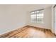 Bedroom featuring wood floors, neutral walls, and a large window with a view of the outdoors at 3872 S Dallas St # 7-304, Aurora, CO 80014