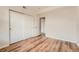 Bright bedroom with wood-look flooring, neutral walls and closet space at 3872 S Dallas St # 7-304, Aurora, CO 80014