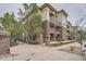 Three-story brick building with balconies and mature trees, landscaping, benches and sidewalks at 3872 S Dallas St # 7-304, Aurora, CO 80014