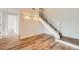 Hallway featuring staircase, wood floors and contemporary lighting fixtures at 3872 S Dallas St # 7-304, Aurora, CO 80014