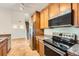This kitchen features wooden cabinets, granite countertops and stainless steel appliances at 3872 S Dallas St # 7-304, Aurora, CO 80014