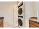 This laundry area features a stacked washer and dryer unit and ample cabinet space for storage at 3872 S Dallas St # 7-304, Aurora, CO 80014