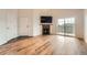 Bright living room featuring wood floors, a fireplace, sliding glass doors and plenty of natural light at 3872 S Dallas St # 7-304, Aurora, CO 80014