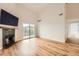 Open living space boasts a fireplace, wood floors, and sliding glass doors to the balcony at 3872 S Dallas St # 7-304, Aurora, CO 80014