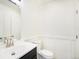 Bathroom featuring a white sink and toilet, with a dark vanity and light fixture at 1113 W 112Th Ave # B, Denver, CO 80234