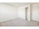 Carpeted bedroom with a closet offering convenient storage, and a bright white door at 1113 W 112Th Ave # B, Denver, CO 80234