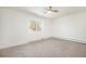 Bedroom with a modern ceiling fan, a view out the window, and cozy carpet at 1113 W 112Th Ave # B, Denver, CO 80234