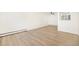 Spacious living room with wood-look floors, baseboard heaters, and a modern ceiling fan at 1113 W 112Th Ave # B, Denver, CO 80234
