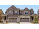 Charming townhome featuring modern architecture, two-car garage, and welcoming front porch at 6740 Juniper Dr, Thornton, CO 80602