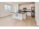 Modern kitchen with stainless steel appliances, white cabinetry, and a center island at 6740 Juniper Dr, Thornton, CO 80602