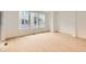 Bright, airy living room with natural light from large windows and light wood floors at 6740 Juniper Dr, Thornton, CO 80602