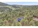 Aerial view of the home nestled among towering trees, offering a serene and private setting at 4574 Picutis Rd, Indian Hills, CO 80454