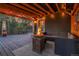 Outdoor living space with a fire pit, comfortable seating, and overhead string lights at 4574 Picutis Rd, Indian Hills, CO 80454