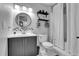 Updated bathroom with a large vanity, black fixtures, patterned tile backsplash, and floating shelves at 4574 Picutis Rd, Indian Hills, CO 80454