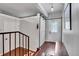 Inviting entryway with new sliding barn door, hardwood floors, staircase, and coat rack at 4574 Picutis Rd, Indian Hills, CO 80454