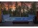 Relaxing hot tub on a private deck surrounded by trees at 4574 Picutis Rd, Indian Hills, CO 80454