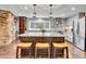 Bright kitchen boasts a large island with seating, stainless steel appliances, and granite countertops at 4574 Picutis Rd, Indian Hills, CO 80454