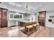Beautiful kitchen with a large island, granite countertops, and stainless steel appliances and hardwood floors at 4574 Picutis Rd, Indian Hills, CO 80454