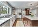Modern kitchen with stainless steel appliances, granite countertops and large windows at 4574 Picutis Rd, Indian Hills, CO 80454