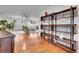 Open-concept living room with hardwood floors, a bookshelf, and a view into a cozy seating area at 4574 Picutis Rd, Indian Hills, CO 80454