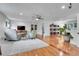 Spacious living room with hardwood floors, comfortable seating, and a seamless flow into other living spaces at 4574 Picutis Rd, Indian Hills, CO 80454