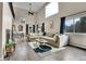 Spacious living room with hardwood floors, high ceilings, and plenty of natural light at 4574 Picutis Rd, Indian Hills, CO 80454