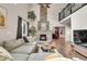 Inviting living room with a stone fireplace, wood floors, and cathedral ceilings at 4574 Picutis Rd, Indian Hills, CO 80454