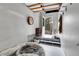 Cozy mud room with dog bed, door to the backyard, and space for storage and pet supplies at 4574 Picutis Rd, Indian Hills, CO 80454