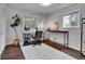Well-lit home office with hardwood floors, neutral walls, and a large window with outdoor views at 4574 Picutis Rd, Indian Hills, CO 80454